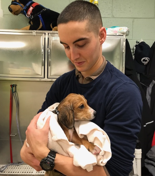 Jason holds a puppy