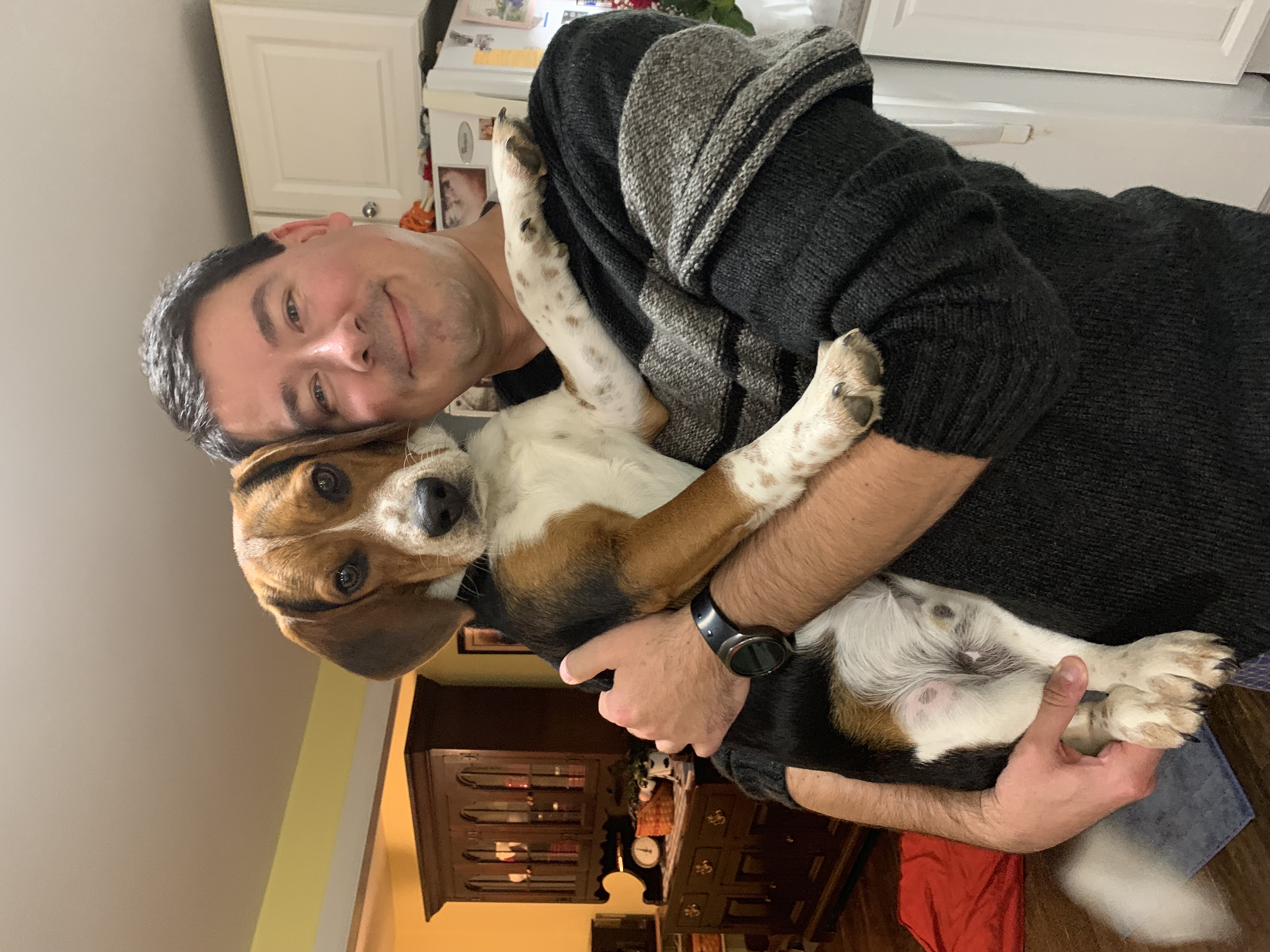 Dan holding a beagle in kitchen